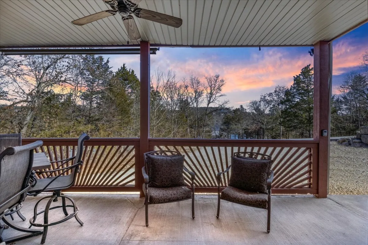 A comfortable outdoor seating area with decorative railings overlooks a scenic natural view, creating an inviting space to relax or socialize. The setting is calm and peaceful, perfect for unwinding after a walk or enjoying a sunset with pets at your side.